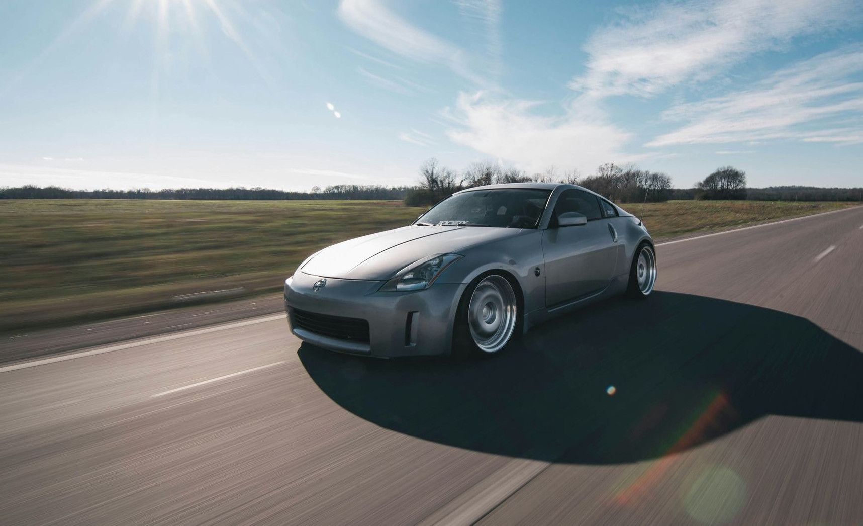 photo of gray coupe on road at daytime